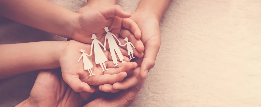 hands holding paper family cutout, family home, adoption foster care, homeless support , mental health, homeschool education, Autism support, domestic violence, social distancing, lockdown isolation